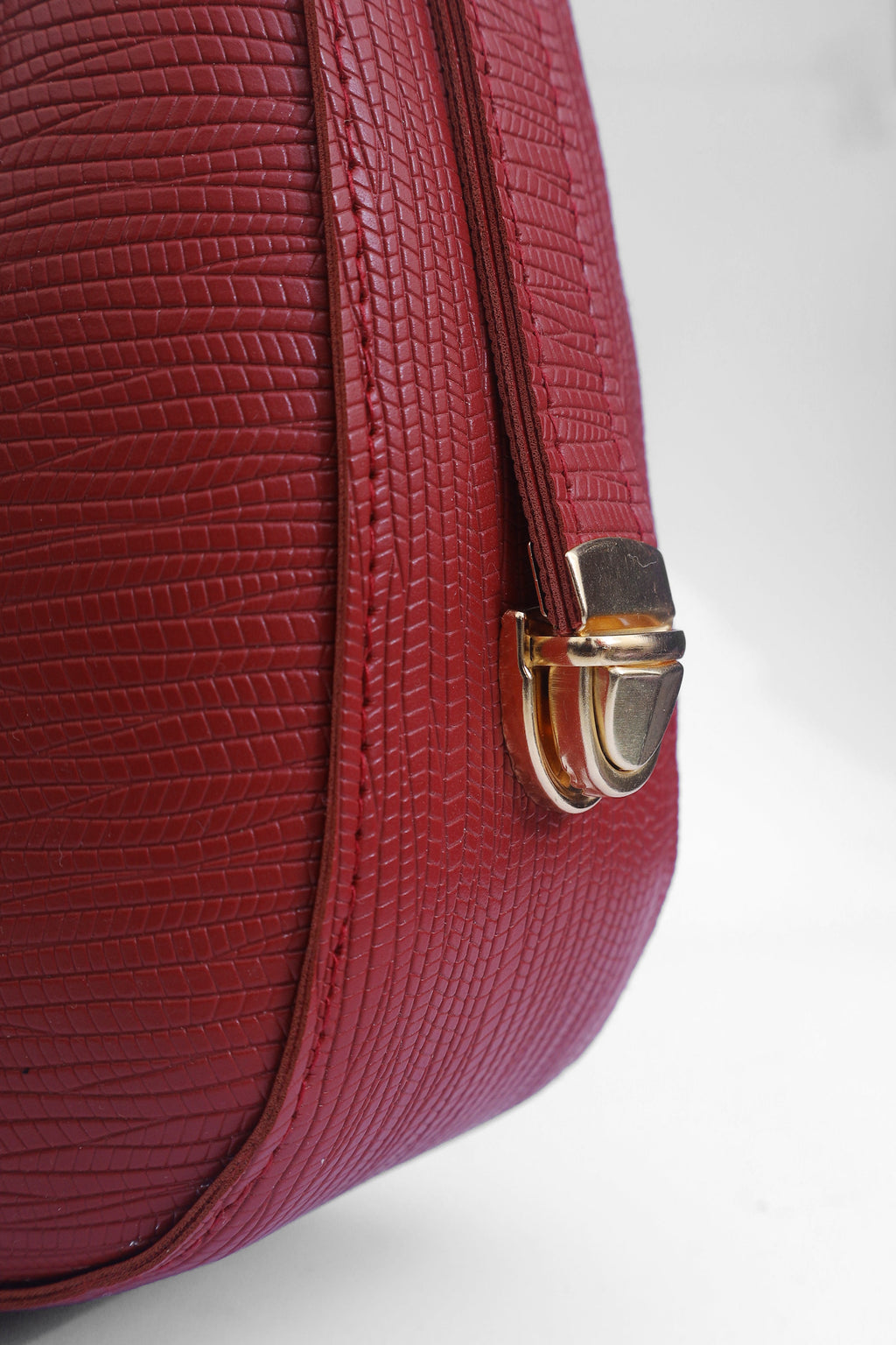 Close-up of a Lyana Ember shoulder bag in red