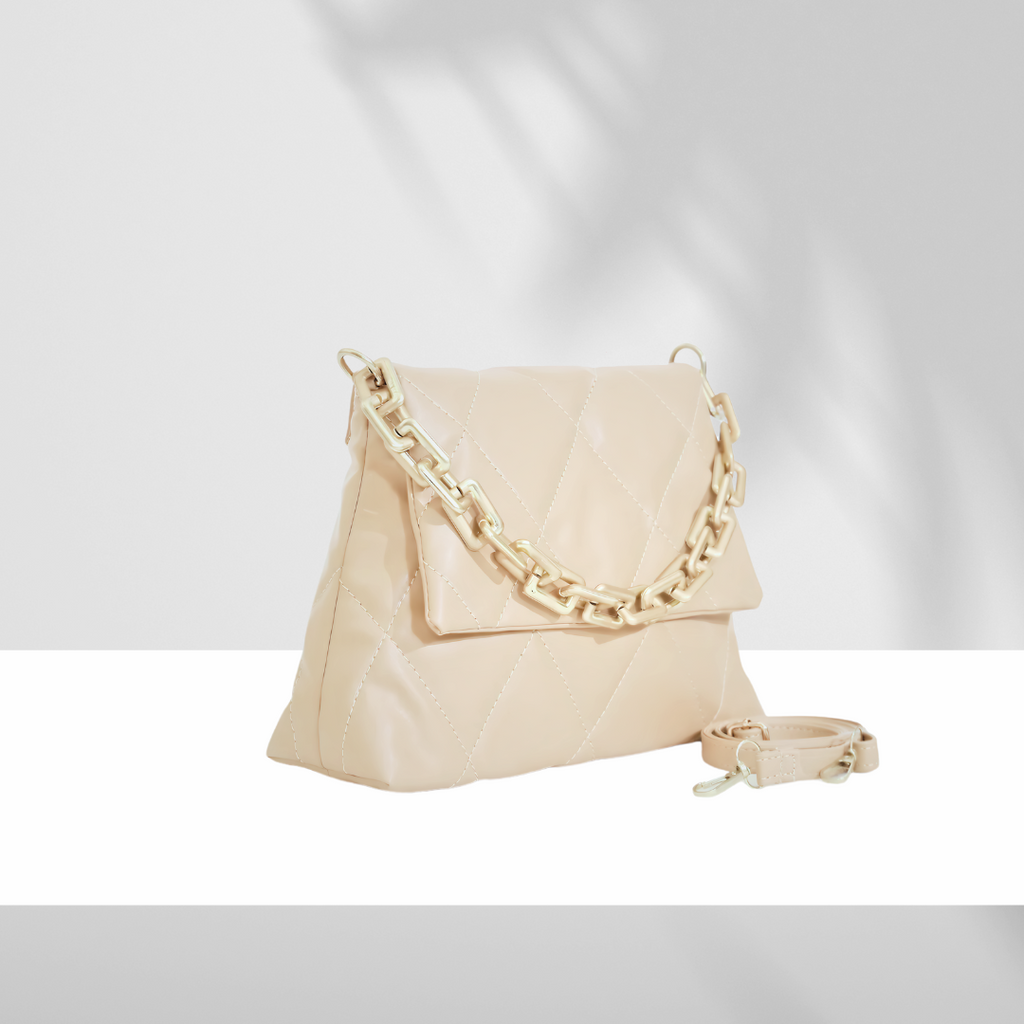 Beige quilted handbag with chunky chain strap and detachable shoulder strap on white background