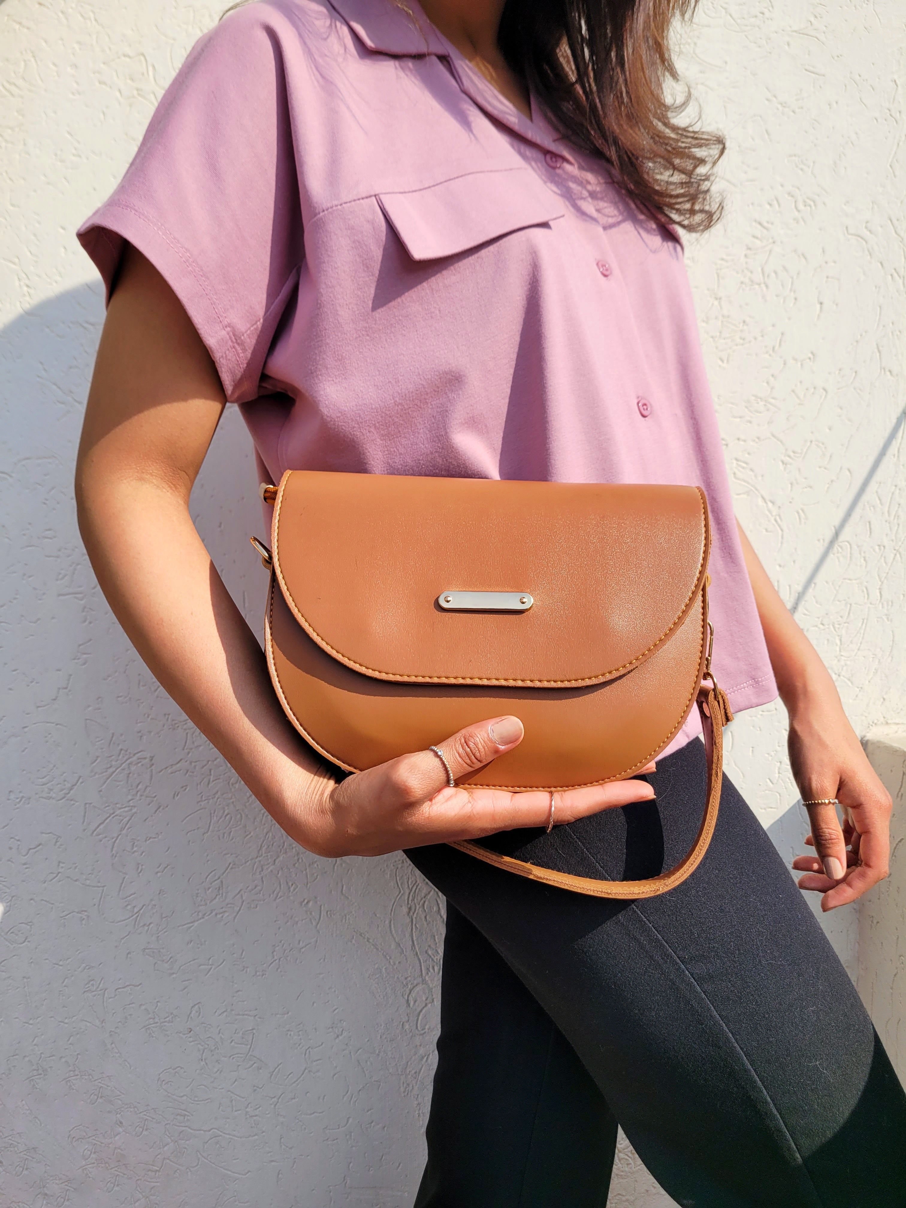 Girl holding chic brown dual strap bag