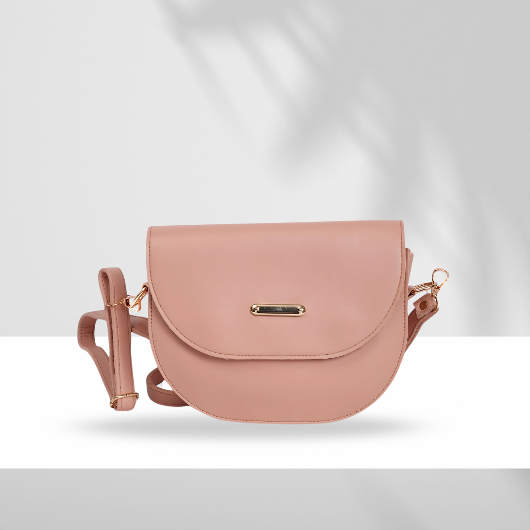 Blush pink crossbody bag with adjustable strap and gold-tone hardware on white background with shadow