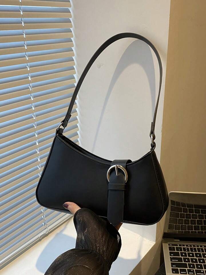 Black Lyana Nysa bag held by a person