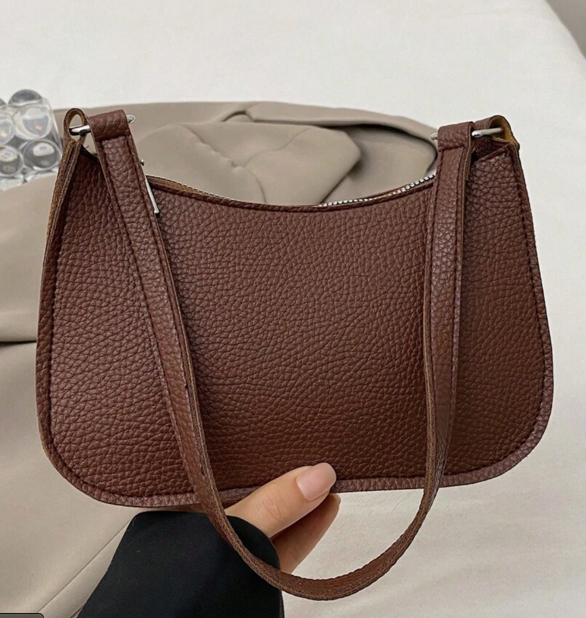 Lyana Rouge bag in brown held by a hand