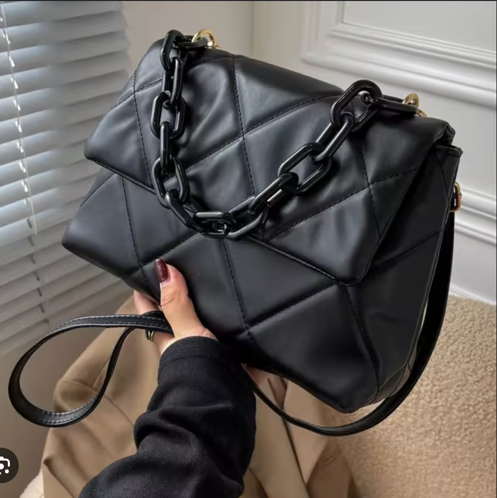 Black quilted faux leather handbag with chunky chain strap, stylish and spacious for everyday use.